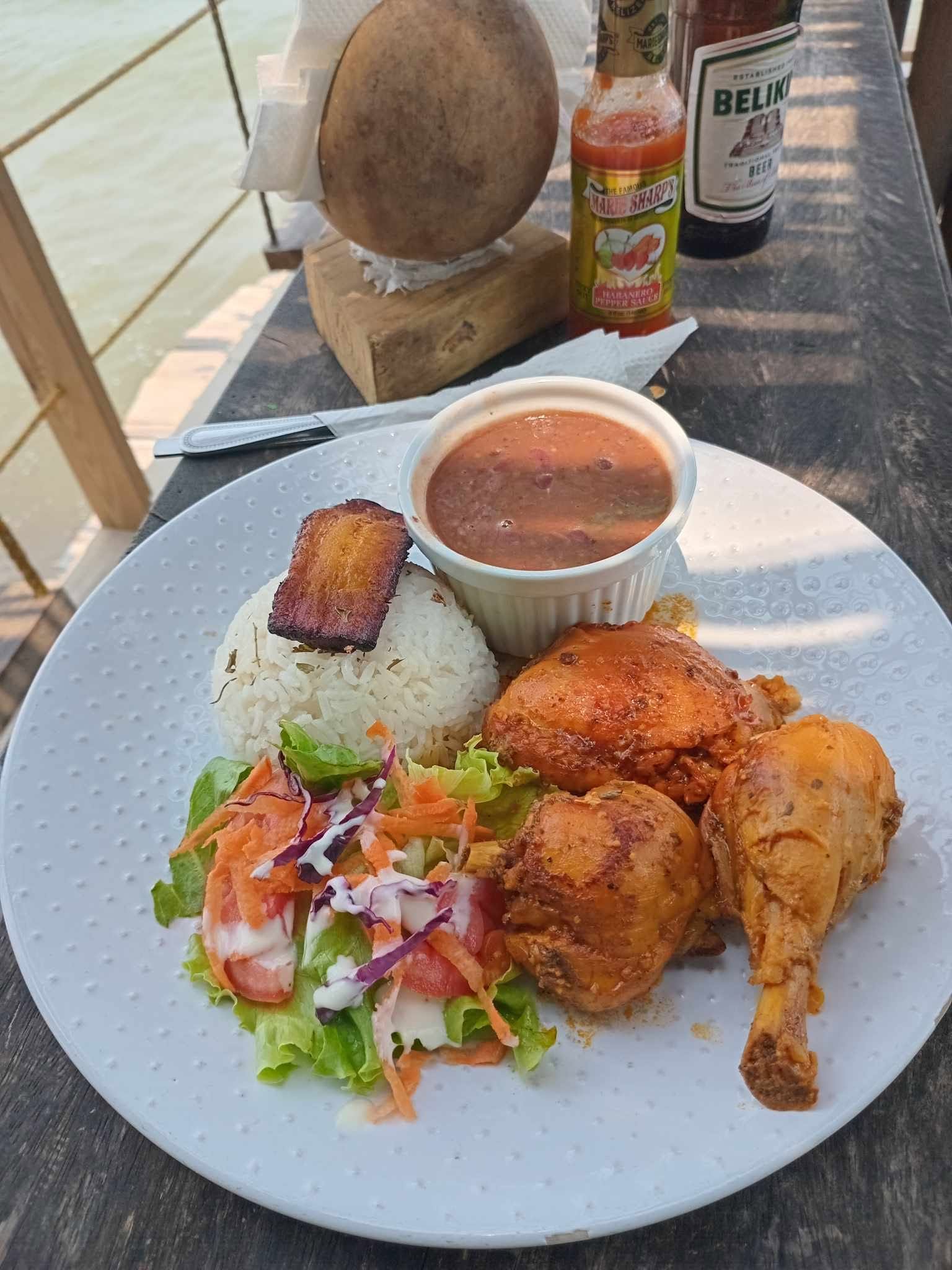 Chicken meal with rice, beans, plantain and salad beside the Caribbean at Swinging Armadillo